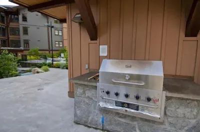 a stove on a stone counter outside of a building at Evolution Whistler, by Lodging Ovations in Whistler