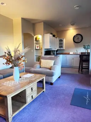 a living room with a couch and a table at Quail Ridge in Kelowna