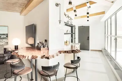 a kitchen with a marble counter and stools at the DOUGLAS, Autograph Collection in Vancouver