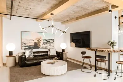 a living room with a leather couch and a table at the DOUGLAS, Autograph Collection in Vancouver