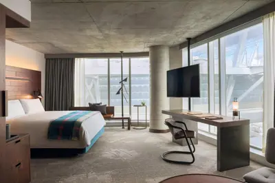 a hotel room with a bed and a desk at the DOUGLAS, Autograph Collection in Vancouver
