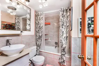 a bathroom with a sink and a toilet and a shower at Diana's Luxury Bed and Breakfast in Vancouver
