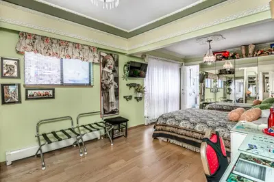 a bedroom with a bed in a room with green walls at Diana's Luxury Bed and Breakfast in Vancouver