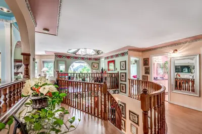 an ornate staircase in a home with wooden railings at Diana's Luxury Bed and Breakfast in Vancouver