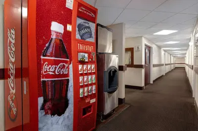 a coke vending machine in a hospital hallway at Days Inn by Wyndham Calgary South in Calgary