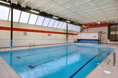 a large indoor swimming pool with a large window at Days Inn by Wyndham Calgary South in Calgary