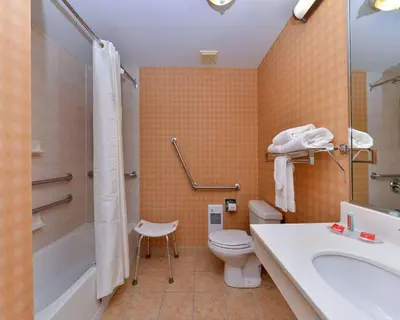 a bathroom with a toilet and a sink and a shower at Econo Lodge Inn & Suites University in Calgary