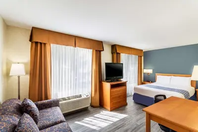 a hotel room with a bed and a flat screen tv at Econo Lodge Inn & Suites University in Calgary