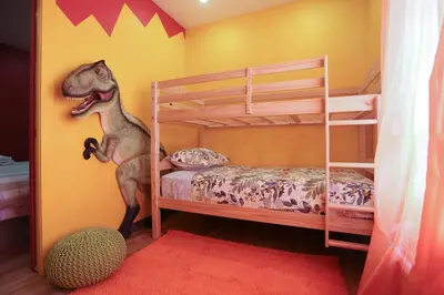 a childs bedroom with a toy dinosaur on the wall at Days Inn by Wyndham Calgary North Balzac in Balzac