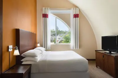 a hotel room with a bed and a window at Four Points by Sheraton Surrey in Surrey