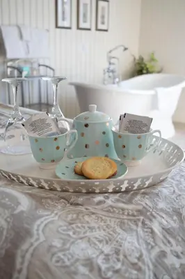 a plate with tea cups and cookies on a table at The Georgetown Inn in Canmore