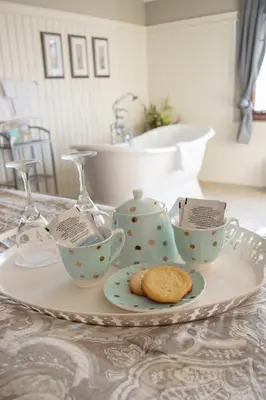 a plate with tea cups and cookies on a table at The Georgetown Inn in Canmore