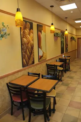 a row of tables and chairs in a restaurant at Hillcrest Motel in Swan Hills