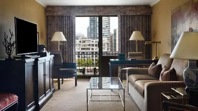 a living room with a couch and a large window at Wedgewood Hotel & Spa - Relais & Chateaux in Vancouver