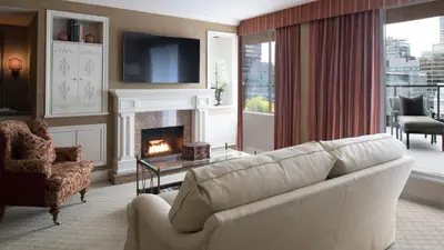 a living room with a couch and a fireplace at Wedgewood Hotel & Spa - Relais & Chateaux in Vancouver