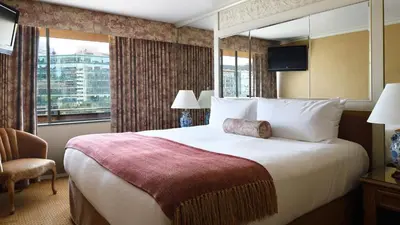 a hotel room with a large bed and a window at Wedgewood Hotel & Spa - Relais & Chateaux in Vancouver