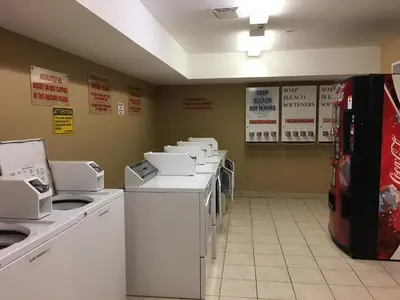a row of washers and dryers in a store at Western Budget Motel #3 Whitecourt in Whitecourt