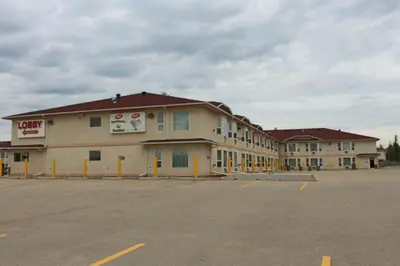 an empty parking lot in front of a hotel at Western Budget Motel #3 Whitecourt in Whitecourt