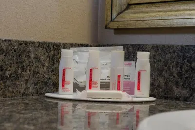 four bottles of moisturizers on a plate on a counter at Ramada by Wyndham Kamloops in Kamloops