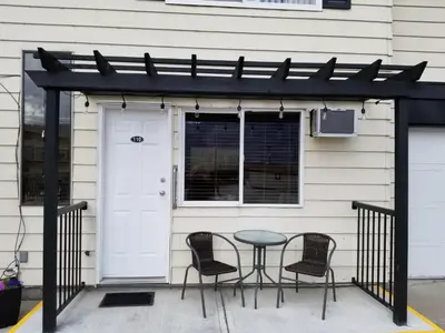 a patio with chairs and a table in front of a house at Osoyoos Lakeview Inn & Suites in Osoyoos