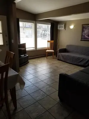 a living room with a bed and a couch at Osoyoos Lakeview Inn & Suites in Osoyoos