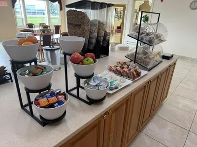 a buffet with bowls of food on a counter at Western Budget Motel Ponoka in Ponoka