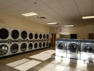 a row of washing machines in a laundry room at Western Budget Motel Ponoka in Ponoka