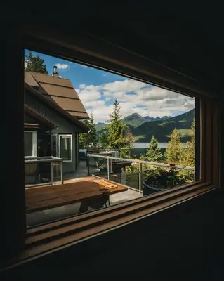 a window of a house with a view of a deck at The Sentinel in Kaslo