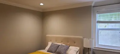 a bedroom with a bed and a window at White Rose House in White Rock
