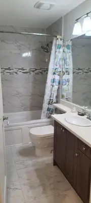 a bathroom with a toilet and a sink and a shower at White Rose House in White Rock