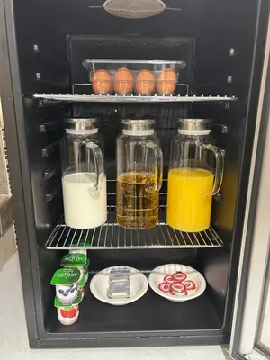 a refrigerator filled with jars of food and drinks at Prestige Aberdeen Lodge Kamloops in Kamloops