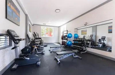 a gym with several treadmills and exercise bikes at Prestige Aberdeen Lodge Kamloops in Kamloops