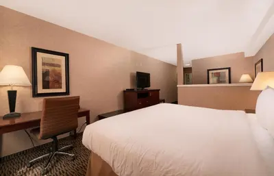 a hotel room with a bed and a desk at Prestige Aberdeen Lodge Kamloops in Kamloops