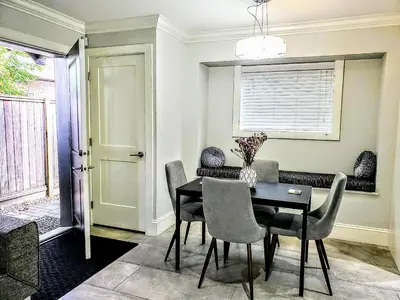 a dining room with a table and chairs at New Urban Modern Main Street House in Vancouver
