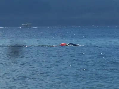 a person laying on their back in the water at Malaspina Strait Cottage in Powell River