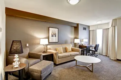 a living room with a couch and a table at Coast Kamloops Hotel & Conference Centre in Kamloops