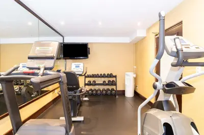 a gym with tread machines and a treadmill at Sandman Hotel and Suites Abbotsford in Abbotsford