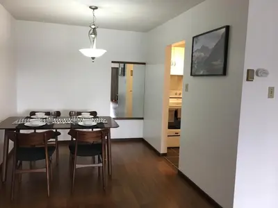 a kitchen and dining room with a table and chairs at Twelve Oaks By Marquee Vancouver in Vancouver