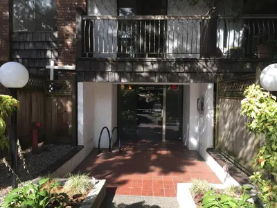 a walkway leading to a building with a balcony at Twelve Oaks By Marquee Vancouver in Vancouver