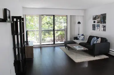 a living room with a couch and a table at Twelve Oaks By Marquee Vancouver in Vancouver