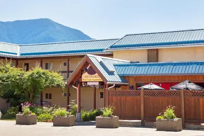 a building with a fence in front of it at The Lodge at Arrow Lakes in Nakusp