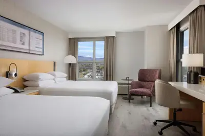 a hotel room with two beds and a desk at Delta Hotels by Marriott Grand Okanagan Resort in Kelowna