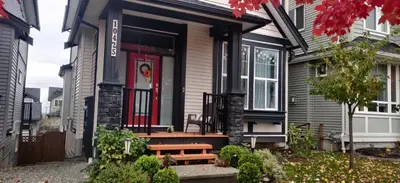 a house with a bench in front of the door at Albion Stay in Maple Ridge District Municipality