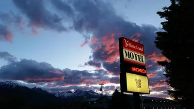 a motel sign in front of a cloudy sky at Yellowhead Motel in Valemount