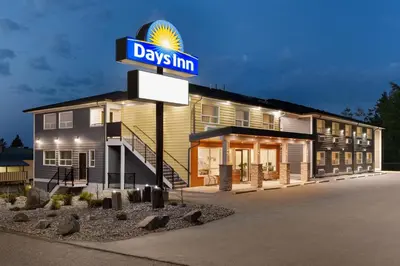 a days inn sign in front of a building at Days Inn by Wyndham 100 Mile House in One Hundred Mile House