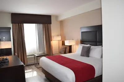 a hotel room with a large bed and a desk at Days Inn by Wyndham 100 Mile House in One Hundred Mile House