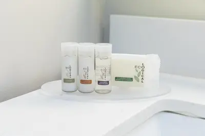 a white shelf with toiletries on a bathroom counter at Days Inn by Wyndham 100 Mile House in One Hundred Mile House