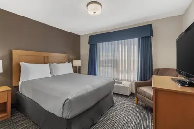 a hotel room with a bed and a television at Best Western Grande Prairie in Grande Prairie