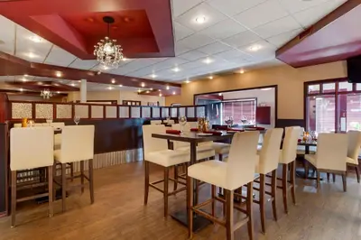 a dining room with white chairs and a table at Best Western Grande Prairie in Grande Prairie