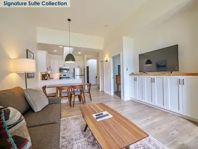a living room with a couch and a table at Waters Edge Shoreside Suites in Ucluelet